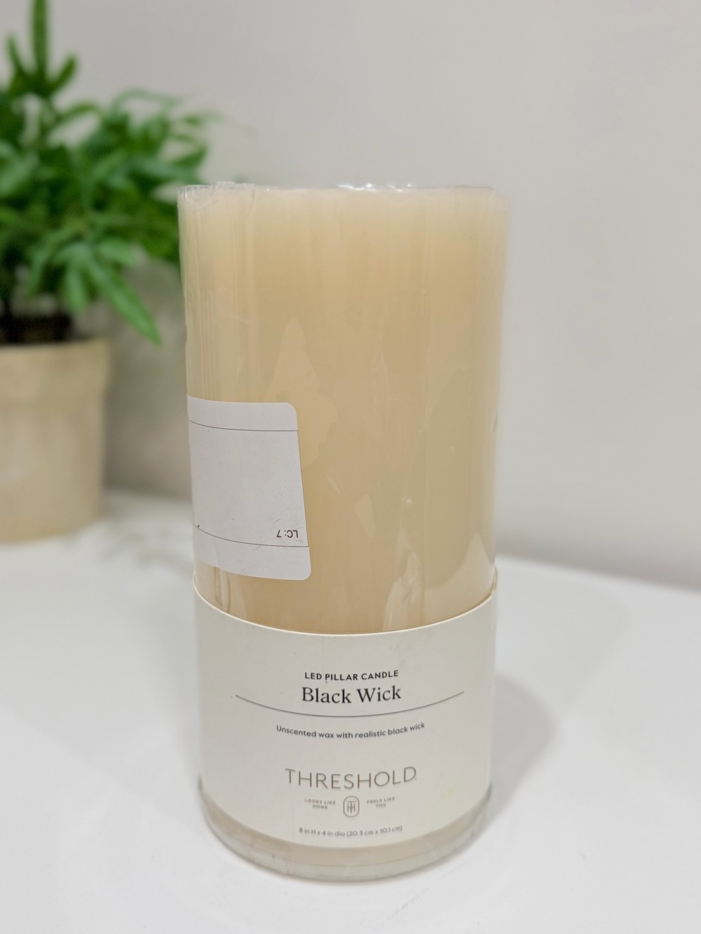Threshold LED pillar candle features a realistic black wick
